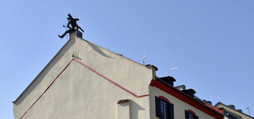 Chimney Sweeper Sculpture on roof Old town of Klaipeda, Lithuania